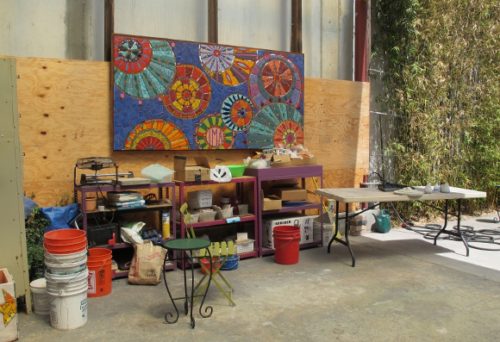 The workroom of the Iinstitute of Mosaic Art, Berkeley, CA, with open garage door and mosaic by Laurel True's 2013 summer mural class. Photo by BF Newhall