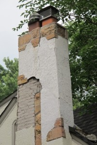 The stucco has fallen away from the chimney on a Tudor bungalow in Minneapolis, revealing the brick work underneath. Photo by Barbara Newhall