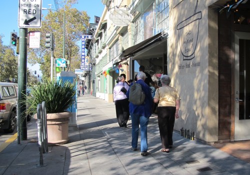 Street scene wiht Sagrada bookstore on Telegraph Avenue, Oakland, CA. Photo by Barbara Newhall