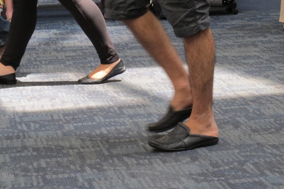 Man at SFO wears baggy shorts, slip-on shoes and hairy legs. Photo by Barbara Newhall