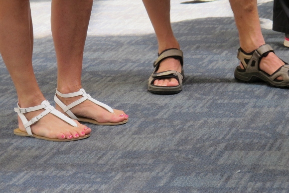 A woman wears delicate tan sandals, a man wears clunky hiking sandals at SFL. Photo by BF Newhall