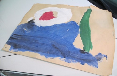 A child's blue green, white and red tempera painting on newsprint. Photo by Barbara Newhall