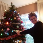 Barbara Falaconer Newhall taking a gift from the family Christmas tree. Photo by Jon Newhall