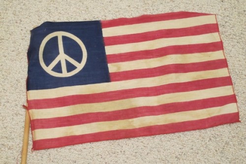 A 1960s era American flag with the peace symbol on a blue field where the stars would normally be. Photo by Barbara Newhall
