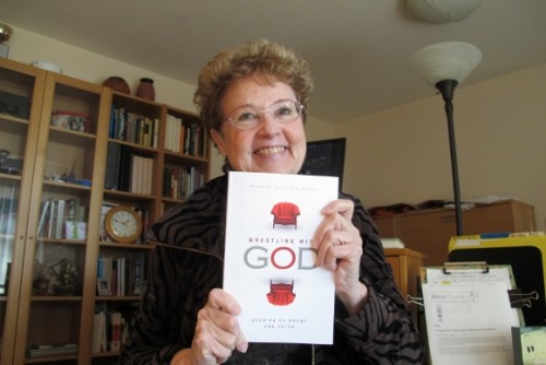 Author Barbara Falconer Newhall joyfully shows off her copy of Wrestling with God with cover design by Michelle Lenger. Photo by Barbara Newhall