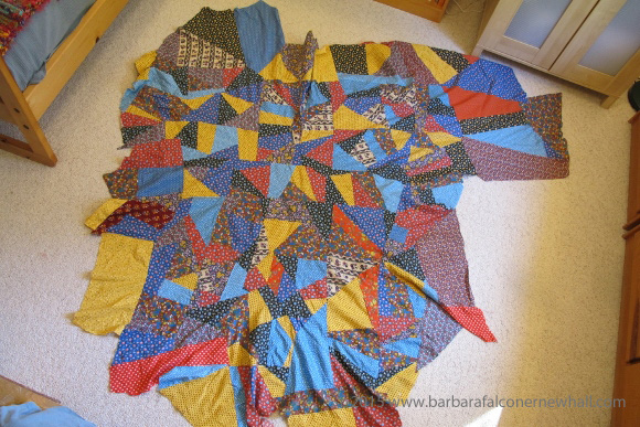 A crazy quilt made of colorful calico is riddled with ripples and waves because the quilter, Barbara Falconer Newhall, failed to stitch the pieces to a flat backing. Photo by Barbara Falconer Newhall