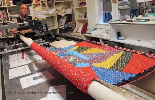 Sue Mary Fox mounted a calico crazy quilt --quilt top, batting and backing -- on her longarm sewing machine in her Berkeley studio. Photo by Barbara Falconer