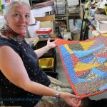 Sue Mary Fox with the colorful calico crazy quilt she completed in her Berkeley studio for Barbara Falconer Newhall. Photo by Barbara Newhall
