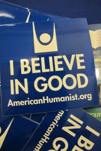 A blue flyer reads "I believe in good., American Humanist.org. Photo by Barbara Newhall