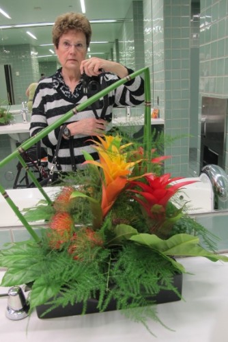 Members of the Flower Committee of the Fine Arts Museums of San Francisco created floral designs to decorate the ladies room at the DeYoung Museum for the 2015 Bouquets to Art Show. Author Barbara Falconer Newhall takes a selfie in the mirror. Photo by Barbara Newhall