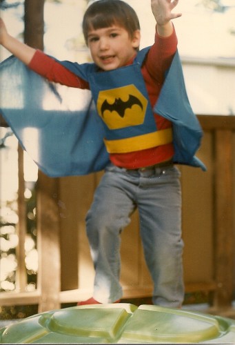 Babysitter challenge. Four-year-old boy dressed as Batman jumps. PHoto by Barbara Newhall