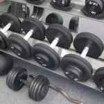 Weight lifing. Dumbbells of various sizes on a rack in a gym. Photo by Barbara Newhall
