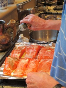 A man prepares salmon fillets for baking. The politics of housework. Photo by Barbara Newhall