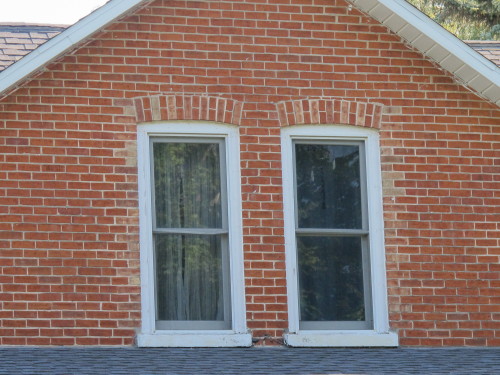 Red brick work around upper story windows on a farm house in Mason county, Michigan. Photo by Barbara Newhall