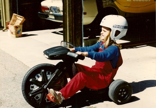girl on tricyclle with helmet. Photo by Barbara Newhall