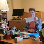 Barbara Falconer Newhall, author of "Wrestling with God: Stories of Doubt and Faith," with her first royalty check in her home office. Photo by Barbara Newhall