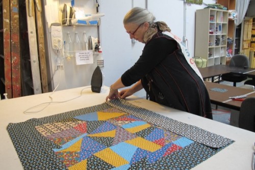 Sue Mary Fox in her Berkeley, California, quilting studio working on crazy quilt for Barbara Falconer Newhall. Photo by Barbara Newhall