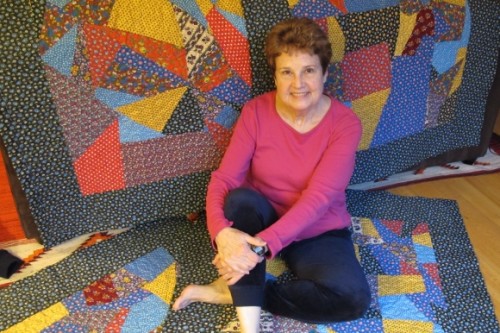 Author Barbara Falconer Newhall with the four calico crazy quilts she designed for the four grandchildren she hopes she'll have. Photo by Jon Newhall