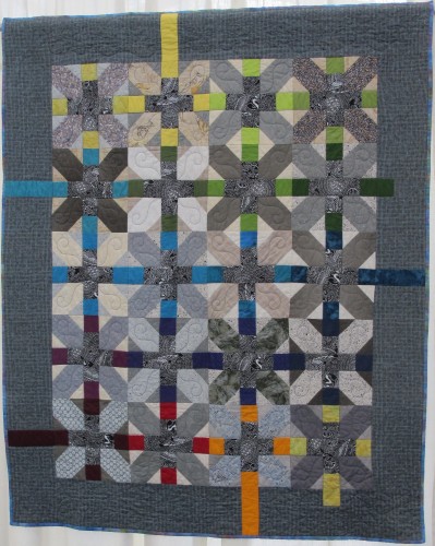 At the East Bay Heritage Quilters show,"Voices in Cloth 2016," in Richmond, CA, HEATHER JACOBSEN presented her angular quilt in shades of blue and gray, "Bo's Quilt 1.0," which her son outgrew as she made it. Photo by Barbara Newhall 