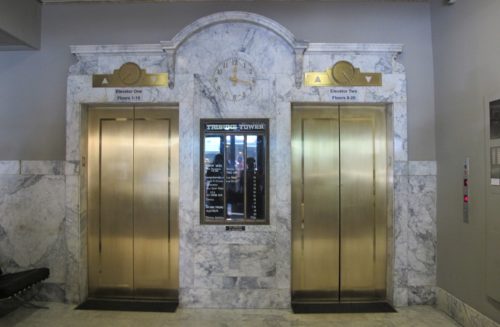 Brass and marble elevator bank at the Oakland Tribune Tower. On April 4, 2016, former employees of the Oakland, California, Tribune, had a wake in honor of the paper's last day of publication. Photos by Barbara Newhall