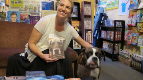 Julie Hill Barton reads from her book, "Dog Medicine," at A Great Good Place for Books, Oakland, CA. Here with a fan, Kirby, a brindle-haired boxer. Photo by Barbara Newhall