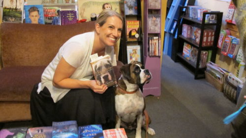 Julie Hill Barton reads from her book, "Dog Medicine," at A Great Good Place for Books, Oakland, CA. Here with a fan, Kirby, a brindle-haired boxer. Photo by Barbara Newhall