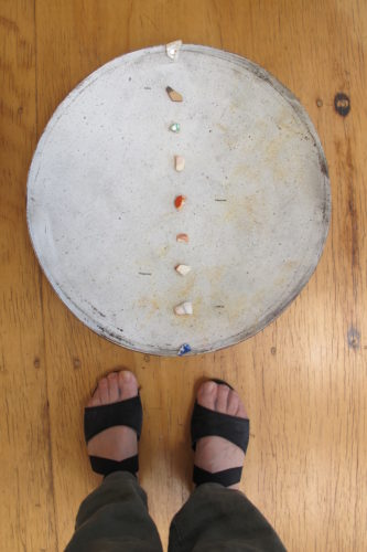 Terra cotta platter by Berkeley ceramicist Nancy Selvin, with small shards from famous pottery makers, including Selvin, which Barbara Falconer Newhall purchased for her 75th birthday. Feet are Newhall's. Photo by Barbara Newhall