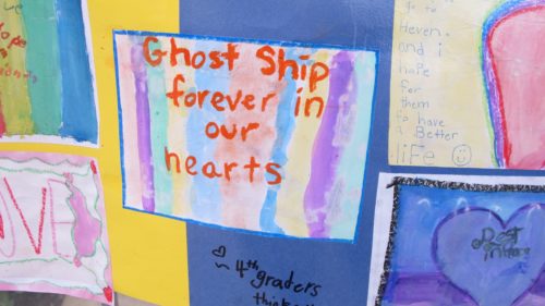A memorial banner by schoolchildren at the site of the Oakland Ghost Ship fire that killed 36 mostly young people, artists, musicians, LGBTQ folks. Photo by Barbara Newhall