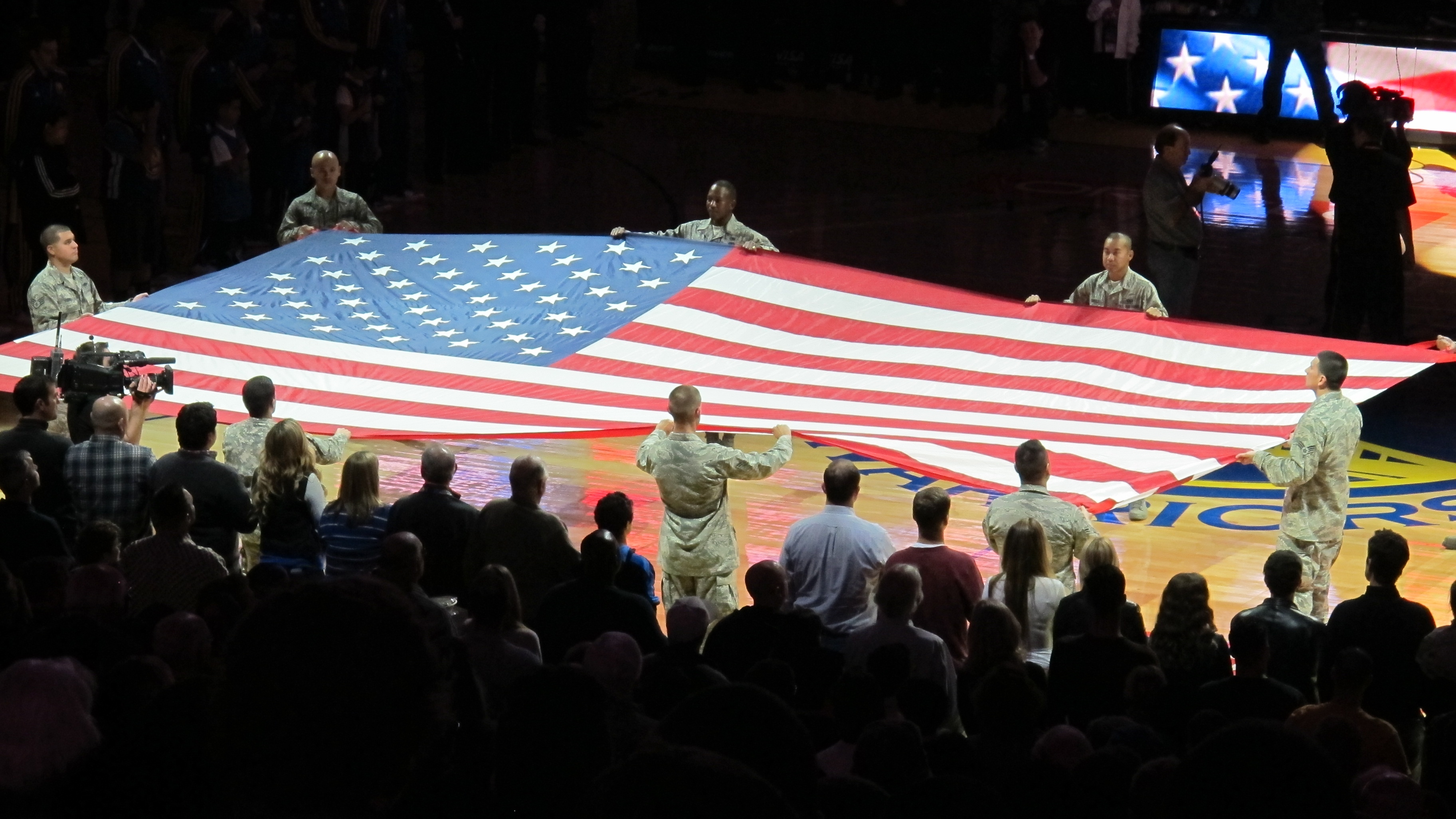 Patriotic holiday gifts: The American flag is spread at a Warriors basketball game in Oakland, CA. Photo by Barbara Newhall