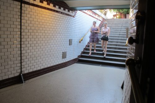 The stairway and entrance to Budapest's Oktogon subway station features white subway tiles and black tile borders. Photo by Barbara Newhall