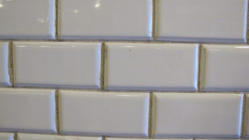 Subway tiles in Budapest's Oktogon metro station with grimy grout. Photo by Barbara Newhall