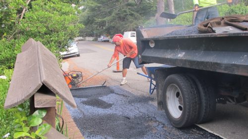 Am I stuck as a writer? I'd rather watch this asphalt crew at work filling in gutter in front of my house. Photo by Barbara Newhall