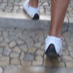 Trendy white sneakers set off slender ankles on the cobblestoned streets of Lisbon's Baixa shopping district. Photo by Barbara Newhall