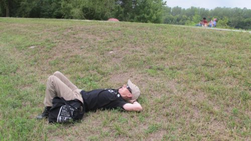 A totality disappointment. Jon Newhall lies down to view the eclipse of the sun from Heritage Park, St. Joseph, MO. Photo by Barbara Newhall